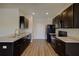 Modern kitchen featuring sleek black appliances, dark cabinets, and wood-look floors, a chef's dream at 1340 Aster Ives Dr, Lawrenceville, GA 30045