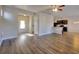 Spacious open-concept living area with wood-look flooring and neutral walls that flows into the kitchen at 1340 Aster Ives Dr, Lawrenceville, GA 30045