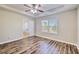 Spacious bedroom featuring tray ceilings, ceiling fan, and an abundance of natural light at 1340 Aster Ives Dr, Lawrenceville, GA 30045