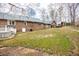 Expansive backyard features a well-maintained lawn, stairs, and mature trees providing shade at 1376 Highway 138 E, Stockbridge, GA 30281