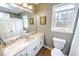 Well-lit bathroom featuring a marble countertop vanity, toilet, and window with natural light at 1376 Highway 138 E, Stockbridge, GA 30281