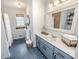 Bathroom featuring a shower with white ruffled curtain, blue vanity, and blue patterned tile flooring at 1376 Highway 138 E, Stockbridge, GA 30281