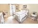 Cozy bedroom featuring a metal frame bed with bedside table, shelving and natural light at 1376 Highway 138 E, Stockbridge, GA 30281
