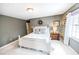 Bright bedroom with white bed frame, soft carpet, and natural light from the window at 1376 Highway 138 E, Stockbridge, GA 30281