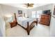 Well-lit bedroom featuring a four-poster bed, wooden dresser and decoratively placed side tables at 1376 Highway 138 E, Stockbridge, GA 30281