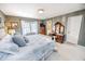 Bright bedroom features a bed with decorative pillows and a classic wooden vanity with mirror at 1376 Highway 138 E, Stockbridge, GA 30281
