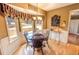 View of the breakfast nook with bay window, chandelier, and backyard views at 1376 Highway 138 E, Stockbridge, GA 30281