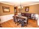 View of the dining room with hardwood floors, chandelier, and dark wood furniture at 1376 Highway 138 E, Stockbridge, GA 30281