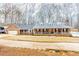 Inviting home featuring a brick facade, dormer windows, and mature trees at 1376 Highway 138 E, Stockbridge, GA 30281