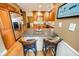 Stylish kitchen featuring wood cabinetry, stainless steel appliances, and a breakfast bar with seating at 1376 Highway 138 E, Stockbridge, GA 30281