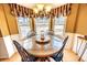 View of the breakfast nook with bay window, chandelier, and views of the backyard at 1376 Highway 138 E, Stockbridge, GA 30281