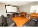 Spacious living room area with hardwood floors, a piano, black leather couches, and a projector screen at 1376 Highway 138 E, Stockbridge, GA 30281