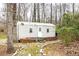 Outbuilding nestled among the trees, featuring a brick base and a metal exterior at 1376 Highway 138 E, Stockbridge, GA 30281