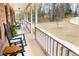 Inviting covered porch with rocking chairs and scenic views of the surrounding landscape at 1376 Highway 138 E, Stockbridge, GA 30281