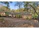 Brick home with a wood deck and a large backyard covered with fallen leaves, surrounded by trees at 2740 Pasco Se Ln, Atlanta, GA 30316