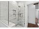 Glass enclosed shower with marble tile, built in shelves, and sleek fixtures at 351 Delmont Ne Dr, Atlanta, GA 30305