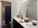 Well-lit bathroom featuring double sinks, modern fixtures, and a shower/tub combination at 801 Rutledge Ct, Woodstock, GA 30188