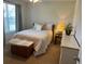 Comfortable bedroom featuring natural light, a bed, dresser, and decorative chest at 801 Rutledge Ct, Woodstock, GA 30188
