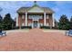 A brick clubhouse with white columns, a central balcony, and a brick-paved entrance at 801 Rutledge Ct, Woodstock, GA 30188