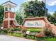 River Park entrance sign with brick pillars, lush landscaping and decorative flowers at 801 Rutledge Ct, Woodstock, GA 30188