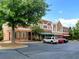 Retail building with brick facade, awnings, large windows, and ample parking at 801 Rutledge Ct, Woodstock, GA 30188