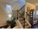 Staircase featuring carpeted steps, dark railings, and trim, complemented by neutral wall colors and decor at 801 Rutledge Ct, Woodstock, GA 30188