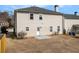 View of the backyard showcasing the back exterior and small concrete patio at 2011 Farm Hill Ct, Stockbridge, GA 30281