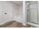 Well-lit bathroom has a soaking tub, walk-in shower and stylish wood-look flooring at 2011 Farm Hill Ct, Stockbridge, GA 30281