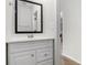 Clean half bath with a sleek mirror and modern fixtures, conveniently located near the main living areas at 2011 Farm Hill Ct, Stockbridge, GA 30281