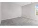Empty bedroom featuring neutral walls, grey carpet and a single window for natural light at 2011 Farm Hill Ct, Stockbridge, GA 30281