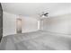 Large empty bedroom features neutral walls and carpet, bright ceiling fan, and plenty of light at 2011 Farm Hill Ct, Stockbridge, GA 30281