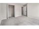 A carpeted bedroom offers an open closet and a doorway to the rest of the home at 2011 Farm Hill Ct, Stockbridge, GA 30281