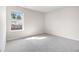 Small bedroom featuring neutral walls, gray carpet and a window for natural light at 2011 Farm Hill Ct, Stockbridge, GA 30281