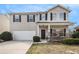 Charming two-story home with a well-manicured front yard and a two-car garage, perfect for a Gathering at 2011 Farm Hill Ct, Stockbridge, GA 30281