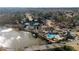 Aerial view of community pool, tennis courts, pond and homes at 6305 Deerwoods Trl, Alpharetta, GA 30005