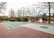 The basketball court is located near a pond with mature trees at 6305 Deerwoods Trl, Alpharetta, GA 30005