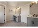 Bathroom featuring double vanity, updated lighting and hardware, framed mirrors and tile flooring at 6305 Deerwoods Trl, Alpharetta, GA 30005