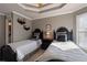 Charming bedroom with stylish beds, tray ceiling, neutral paint and ensuite bathroom access at 6305 Deerwoods Trl, Alpharetta, GA 30005