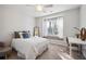 Bright bedroom with neutral paint, plush carpet, a window seat and a ceiling fan at 6305 Deerwoods Trl, Alpharetta, GA 30005