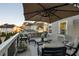 Inviting outdoor deck features comfortable seating, an umbrella, and neighborhood views at 6305 Deerwoods Trl, Alpharetta, GA 30005
