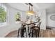 Bright dining area with modern table and chairs, attractive light fixture, and bright windows at 6305 Deerwoods Trl, Alpharetta, GA 30005