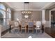Elegant dining room with a large table, decorative chandelier, and arched windows at 6305 Deerwoods Trl, Alpharetta, GA 30005