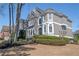 Attractive gray two-story home with well-maintained landscaping and traditional architecture at 6305 Deerwoods Trl, Alpharetta, GA 30005