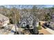 Charming home featuring a landscaped yard, driveway, and mature trees at 6305 Deerwoods Trl, Alpharetta, GA 30005