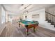 Spacious game room features billiard table, stairs to upper floor, and seating area at 6305 Deerwoods Trl, Alpharetta, GA 30005