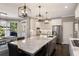 Bright kitchen featuring a large island, stainless steel appliances, and a cozy breakfast nook at 6305 Deerwoods Trl, Alpharetta, GA 30005