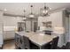 Stylish kitchen with white cabinets, a large marble island, and stainless steel appliances at 6305 Deerwoods Trl, Alpharetta, GA 30005