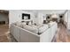 Open-concept living room features a large sectional sofa, game room, and fireplace at 6305 Deerwoods Trl, Alpharetta, GA 30005