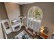 Open-concept living room featuring a fireplace, built-ins, and large arched windows at 6305 Deerwoods Trl, Alpharetta, GA 30005