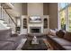 Inviting living room features a stone fireplace, built-in shelves, and a staircase offering backyard views at 6305 Deerwoods Trl, Alpharetta, GA 30005